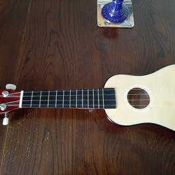 UKULELE WITH FOR BOOKS AND A UKULELE BAG . EXCELLENT CONDITION PICKUP ONLY.