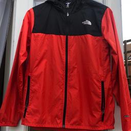 North Face windbreaker  
size Youth/ junior L/G
red & black 
2 zip pockets 
The North Face logo on front & back & written in white down arm. 

**ALSO LISTED ON OTHER SITES**