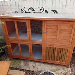 5ft Double rabbit hutch with ramp.  I used vinyl on the floors to protect the wood.  One area will need redoing.   It has been chewed in places but it's still in very good condition. 
I have also added some wood on the bottom right hand door just to give some more protection. 

This is collection only and will need two people to lift it.