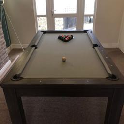 Selling my *As New* pool table this item can be used for playing pool or table tennis but also comes with ash table top cover so can be used as an elegant dining table.

also including;
* Full set of pool balls and four que's as seen in the image
* Nets and paddles for table tennis use

This is a lovely multi functional piece of furniture finished in an oak grey tone with light grey cloth.

Bargin at £300 or very nearest offer!

COLLECTION FROM EAST LONDON- CASH ON COLLECTION ONLY PLEASE!!