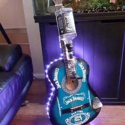 brand new guitar with Jack Daniels logo. bar optic .deluxe bottle opener. multifunction lights with remote control and wall hanger. this guitar looks cool wall hung or understand perfect for any room batteries included. stand and Bottle not included. Hermes delivery in the UK £12