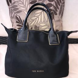 100% genuine Ted Baker black nylon tote bag with gold tone Ted Baker branded hardware. Main zip compartment with two handles. Gold tone branded studs on the bottom. Excellent condition. I can post.