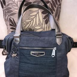 100% genuine Kipling handbag. Navy blue Kipling tote bag with silver tone Kipling branded hardware and original monkey charm. Zip across the top with two handles, internal zip pocket and mobile phone pocket. Front zip pocket. Immaculate condition, hardly used. I can post.