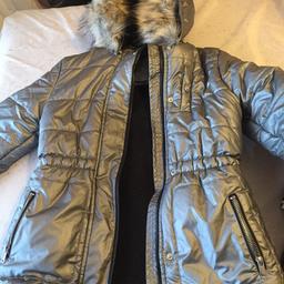 Grey shimmer padded coat with hood and pockets . 9-10 years from Sainsbury’s In vgc Ng19 or can deliver or post for small fee