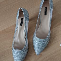 silver sparkling heeled shoes. only worn once for about 2 hours. still in great condition. has extra heel tip caps included. size 8 on box but feels like 7/7.5. bought originally for£30.