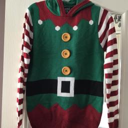 Elf Christmas jumper size small 10 by SEASONS GREETINGS
3 yellow buttons down the front red and white stripey arms , green hood and white Pom Pom