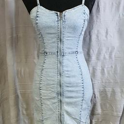 Stone wash, fade distressed, stretchy dress, zip up front with spaghetti straps. Very flattering tight fit. Just needs ironing out other wise great condition