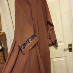 here you have a brand new dark peach abaya

it's open at the front with pop buttons
really beautiful embroidery on the arms

size 52

gorgeous top quality dubai like material

comes with a matching scarf 

lovely item can be worn with anything casual or dressy

£25 ono