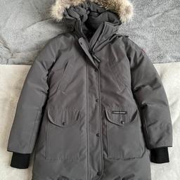 LIKE NEW - WORN ONCE

Women’s Victoria dark grey fur-trimmed, feather down Canada Goose Arctic-Tech shell parka.

Padded, detachable coyote fur trim at drawstring hood, buckled hood trim, designer plaque at sleeve, side pockets, concealed ribbed jersey cuffs, back vent, internal drawstring waist, internal shoulder straps, internal pockets, full quilted lining. Concealed zip and press stud fastenings through front.

Size medium.
