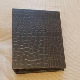 Faux leather hard cover with plastic inserts 

Brand New Pristine Condition