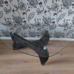 A distinctive glass table, in a good condition with some slight scratches to top and a very small scuff to leg (hardly noticeable as seen in picture). 

Height 40cm
Width 120cm