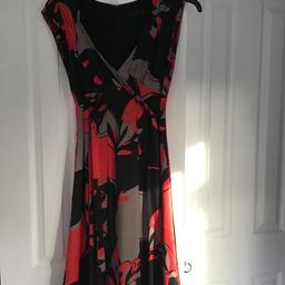 Black red and silver fitted knee length dress with crossover tie to front . Matching ted baker clutch bag,worm once