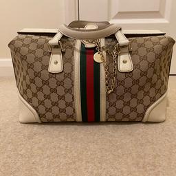 genuine Gucci bag with key lock includes one zip compartment inside. spare key also provided 
used - please refer to photos for true conditions there are signs of wear on this bag. Message for more pics 

approx measurements: 
width 15.5 inches 
height 8 inches 

no refunds