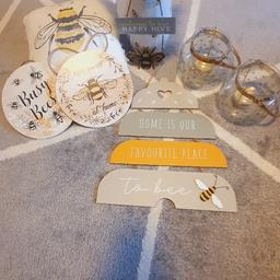 Bee decorations include:
2 x glass tea light jars
2 x circular wooden hanging signs
Bee vase
Artificial sunflowers 
1 x hanging wooden worded sign
1 x small hanging metal
Bee pillow small

Postage cost is £7.99 Royal mail medium parcel