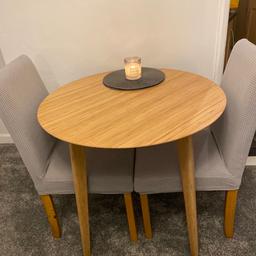 IKEA circular table 80cm and 2 dining chairs. Perfect for smaller spaces. Chairs are upholstered in heavy beige linen but I used with grey chair covers which are included. 
Not purchased as a ‘set’ but work really well together. Collection or possible local delivery.