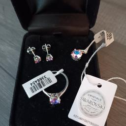 New and unopened sterling silver swarovski set includes earrings ring and pendant