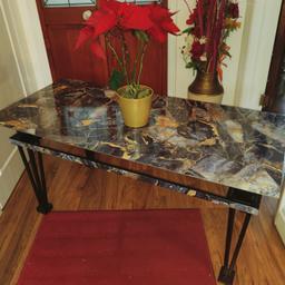 Refurbished Glass top coffee table with gold flecked marble effect covering and black metal legs. Size measures 21ins W x 46 ins L x 21 ins H
Collect from Wallington SM6
Ask about local delivery