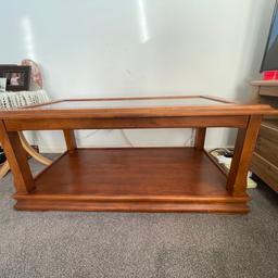 Good quality wood coffee table. Brought from Spain, has a few marks from scratches and heat. Glass has also got a scratch and a chip in one of the corners but otherwise in good condition. 61 x 111 x 50 .Collection only