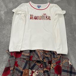 Rosalita skirt set age 10 in immaculate condition long sleeved cream too featuring ROSALITA in tartan lettering & red dismantle detail. Skirt above the knee with tartan/Teddy design