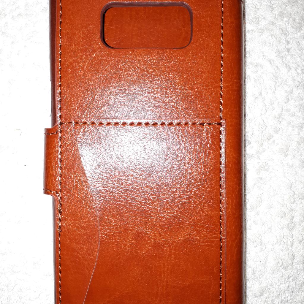 As new tan leather wallet case for Samsung Galaxy S8 Plus by Taken. Has slots for cards and comes with a soft drawstring bag. As well as free collection from us, we also offer UK postal delivery for £3.19.