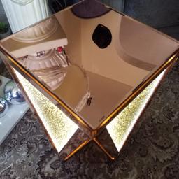 BRAND NEW!!! .. JM!! .. JULIEN MACDONALD!! .. OBE!! .. WELSH FASHION DESIGNER!! .. AS HIS OWN JM RANGE!! .. .. WHICH IS EXCLUSIVE!! .. .. AND THIS IS ONE & A REAL SHOW PIECE!! .. .. BE THE ENVY OF YOUR FAMILY AND FRIENDS!! .. .. ENCAPSULATED CRYSTAL SIDE TABLE/LAMP!! .. IN ROSE GOLD!! .. .. BRAND NEW!! .. AND THE CRYSTAL FURNITURE IS ALWAYS TRENDING!! .. THIS SQUARE SIDE TABLE SHOWCASES AN ARROW STYLE FEATURE!! .. WITH A RECTANGULAR BEVEL CUT GLASS BORDER!! .. WITHIN IS A CLEAR GLASS PANEL TO REVEAL ENCAPSULATED ROSE GOLD CRYSTALS!! .. WHICH LIGHTS UP A WARM GLOW OF LED'S!! .. .. COST OVER £240 + £6 P/P ON QVC!! .. .. POSH SHOPS .. SIMILAR WOULD BE INXS OF £350!! .. .. QUALITY AND WEIGHTY!! .. .. AND A REAL SHOWSTOPPER!! .. .. BE THE ENVY OF YOUR FRIENDS AND FAMILY!! .. .. COMES FROM SMOKE FREE HOME!! .. BUYER COLLECTS!! .. OR .. COULD DELIVER LOCALLY 4 A SML FEE!!