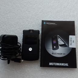 Brand new Motorola black Razr v3 mobile phone with manual.