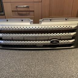 Range Rover Sport grill. The grill had headlight guards attracted to it. There is a crack on one of the holes & the hole below the stud has stuck in. Also included is a pair of headlight guards.