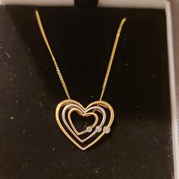 Brand new in Box
Beautiful 9ct Gold 3 Diamond Triple Heart Necklace 
Each heart is movable but stacks into each other to sit flat on the decolletage.
2 yellow gold and a middle white gold heart, each depicting a diamond 
18in chain
Brand new & Boxed 
Collect ST13 or posted special delivery