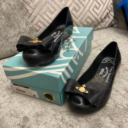 These lovely black shoes goes with most things. Beautiful bow detail with gold sign. From a clean smoke free home.