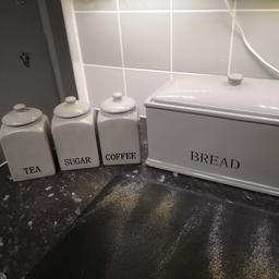 Grey ceramic bread bin and tea, coffee and sugar canisters and ceramic biscuit jar. 
Excellent condition