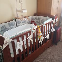 Brown / Walnut Cot Bed with Drawer and Mattress
Height adjustable- 3 levels.
Converts to toddler bed.
Converts to sofa/ day bed.
Mattress
Teething rail on one side.

Very sturdy and in very good condition, with no damage just some small marks.