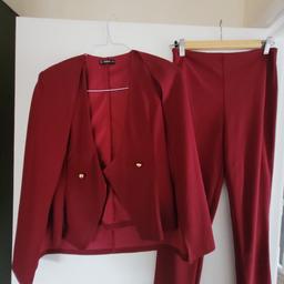 ruby trouser suit, jacket has cape arms & gold buttons