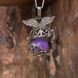 Angel Caller', as the soothing chime is said to be heard by the angels, giving protection, guidance and comfort to the wearer- young or old, so it makes a great gift of hope and protection. beautiful sliver plated filigree casing ( dose not tarnish ) with a purple ball inside that chimes when moved ,