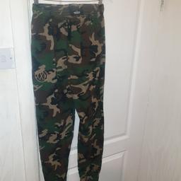 10 deep camouflage tracksuit bottoms BN unworn in large to Xl unisex drawstrings with tapered cinched bottom embroidered xxx on left thigh two side pockets one off piece

Length 100cm waist across 33cm waist to crotch  30cm inside leg 74cm width of leg 27cm heel width 13cm

All used  items inspected dry cleaned and ironed
Prices negotiable sensible offers only please

I sell all brands
Dead stock dread stock
100% genuine All excluey get busy dripping or get busy drying!!