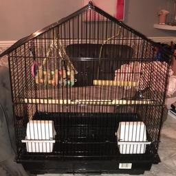Black bird cage has removable grill at the bottom , big door to open and easy sliding doors to get the water and food trays in , has a pitch and 2 slings plus mirror