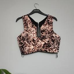 BNWT New Look UK14 shiny crop top. Collection or postage (Royal Mail second class with signature £4,20). Any questions feel free to ask. All my items are on other sites. Open on sensible offers on bundle. Please have a look on my other items