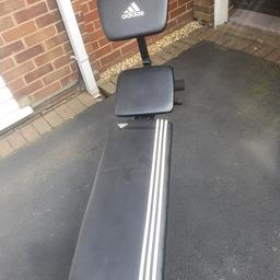 An adjustable adidas weight bench with preacher attachment.