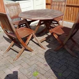 Nova wooden garden table and four chairs. Very heavy. Buyer collects. These can be restored or used as they are, options are endless