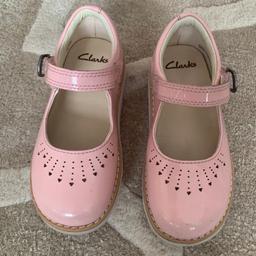 Clarks beautiful pink Crown Jump girl’s shoes cut a classic Mary Jane silhouette with a durable and practical twist.

They stand upon chunky white cleated EVA soles, a lightweight and shock absorbing foundation for the sweet style, and fasten securely via adjustable buckle fastenings. 

Size: 7.5 U.K. toddler size
In very good condition with minor scratches on the toes area
From pet free/smoke free home
Grab a bargain