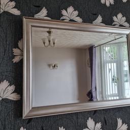 Large heavy mirror Silver frame
Very slight chip in glass and frame where it fell off wall, not that noticeable until you get close. I have zoomed in on it in the photo.
41" x 29" inches approx 