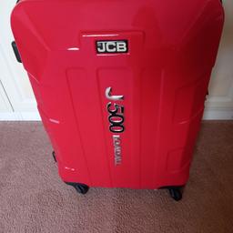New red hard loadall suitcase by JCB.4 wheel spin.Approx size 65cmx48cmx27cm.Pick up only.Rochdale.