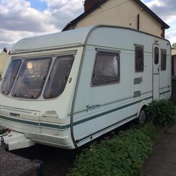 Lovely 5 birth caravan. Awning and cover and lots of accessories included. Also has a kitchen with fridge and a bathroom with toilet and shower. Does need a little tlc.