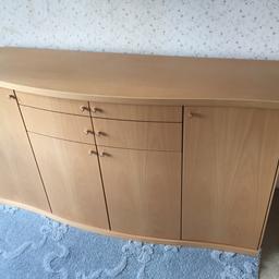 This is a beech effect dining or lounge side board . Very modern in appearance . Also includes a matching wall mirror. The cabinet measures 
156 cm long 44cm deep 86 cm heigh