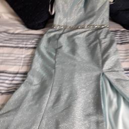 Beatifull   light blue  very sparkly  stunning dress all bling blings running from the kneck over back of shoulders and right down to waste that's on back of dress on frunt slit up one leg full flow  and bling belt on frunt  
 NEVER BEEN WORN