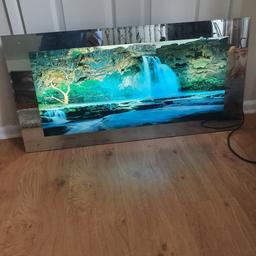 lights up and sounds of the waterfall width is 19inch lenth is 38.5 hooks on back to hang on wall selling for fam member sligh chip corner cant be seen up