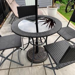 7 piece patio set,table in black rattan effect with black glass top.compromises of 4 chairs,table,tilting parasol and base. Good fair clean condition,collection only. 