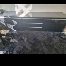 ikea black gloss long TV unit with 2 draws and 3 shelves.  few scratches on top but not visible if tv is on top