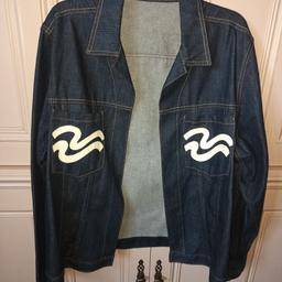 Lovely denim jacket with detailed stiching.  Has white design on the pockets.
