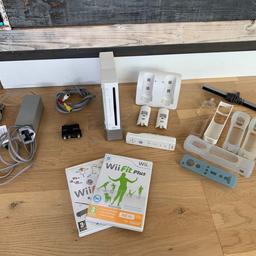 Nintendo Wii console with remote control, charging dock, multiple skins, 2 games and all cables. All in good working order have signs of use but nothing major.