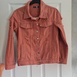 ladies boohoo denim coat torn look pink colour it does say a size 6 but it is an over size style would fit a size 10 still like new
